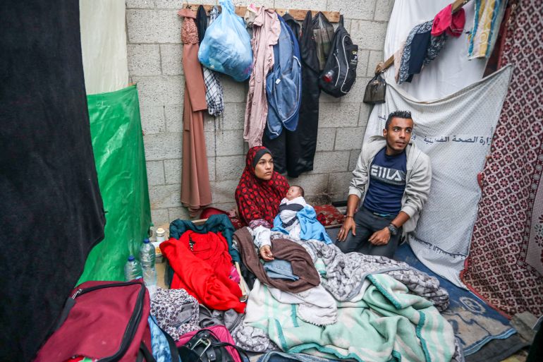 Esraa al-Jamalan gave birth to her daughter on November 24 and now lives in a makeshift tent in Deir el-Balah in central Gaza [AbdelHakim Abu Riash/Al Jazeera]