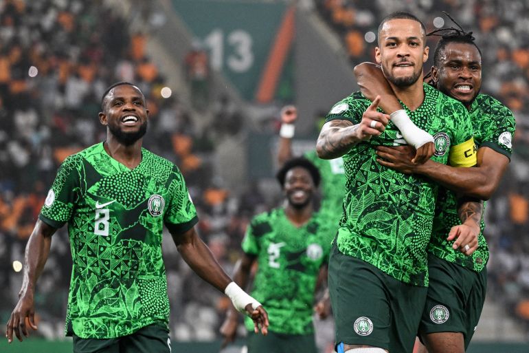 Nigeria's defender #5 William Troost-Ekong (2R) celebrates with teammates after scoring his team's first goal from the penalty spot during the Africa Cup of Nations (CAN) 2024 semi-final football match between Nigeria and South Africa at the Stade de la Paix in Bouake on February 7, 2024. (Photo by Issouf SANOGO / AFP)