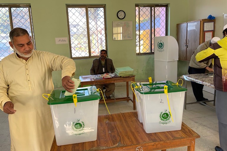 A voter casts his vote in the election at a polling station in Islamabad