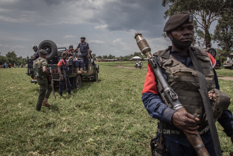 A soldier of the Democratic Republic of Congo's armed forces holds his weapon during a security patrol around the Kiwanja airfield days after clashes with the M23 rebels in Rutshuru, 70 kilometers from the city of Goma in eastern Democratic Republic of Congo, on April 3, 2022. (Photo by Guerchom NDEBO / AFP)