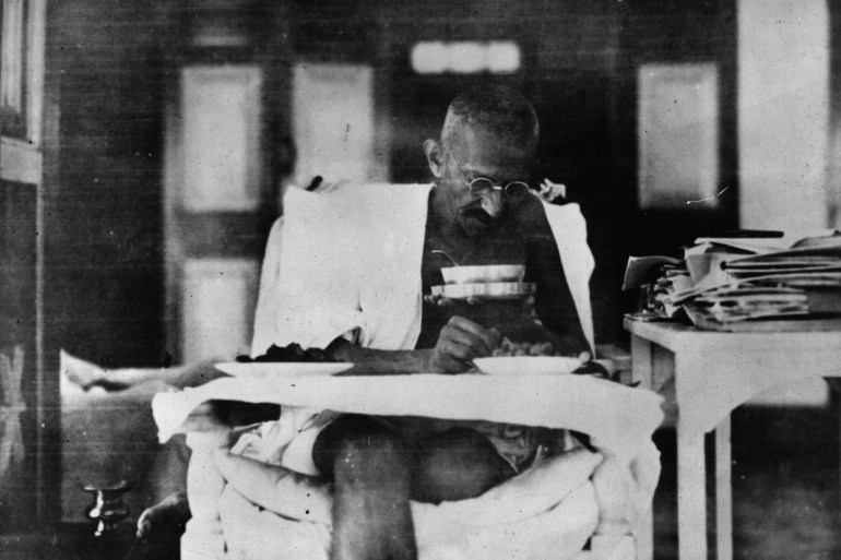Indian nationalist leader Mahatma Gandhi (Mohandas Karamchand Gandhi, 1869 - 1948) eating at his home, whilst living in seclusion after his release from prison by the British authorities. (Photo by Topical Press Agency/Getty Images)