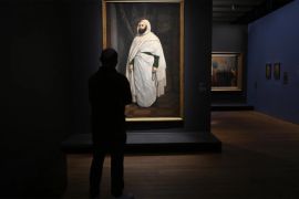 A visitor looks at a painting of Emir Abdelkader during the exhibition "Abdelkader, a figure of the Algerian independence" at the Mucem Museum in Marseille, southern France, on April 5, 2022. Seen as one of France's worst enemies in the late 19th century, Emir Abdelkader, the Algerian military hero who resisted France's colonisation of the North African country, is considered one of the founders of modern-day Algeria for his role in mobilising resistance to French rule. (Photo by Nicolas TUCAT / AFP) / RESTRICTED TO EDITORIAL USE - MANDATORY MENTION OF THE ARTIST UPON PUBLICATION - TO ILLUSTRATE THE EVENT AS SPECIFIED IN THE CAPTION - RESTRICTED TO EDITORIAL USE - MANDATORY MENTION OF THE ARTIST UPON PUBLICATION - TO ILLUSTRATE THE EVENT AS SPECIFIED IN THE CAPTION
