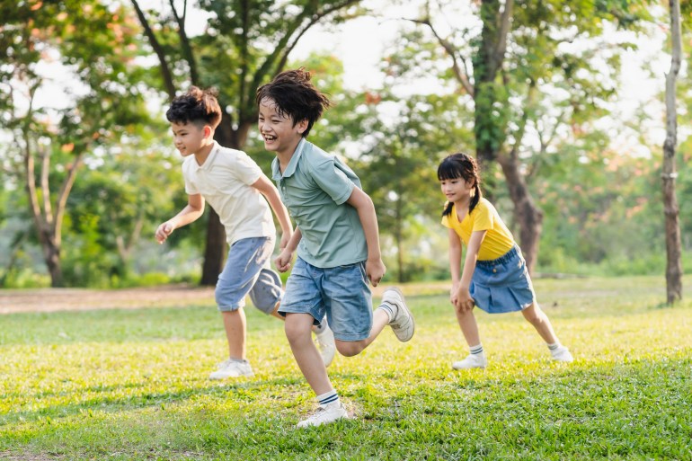 group image of asian children having fun in the park; Shutterstock ID 2335173819; purchase_order: aljazeera ; job: ; client: ; other: