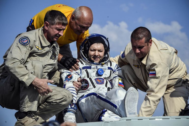Ground personnel help Russian cosmonaut Oleg Kononenko to get out of the Soyuz MS-11 capsule shortly after landing in a remote area outside the town of Dzhezkazgan (Zhezkazgan), Kazakhstan, on June 25, 2019 Alexander Nemenov/Pool via REUTERS