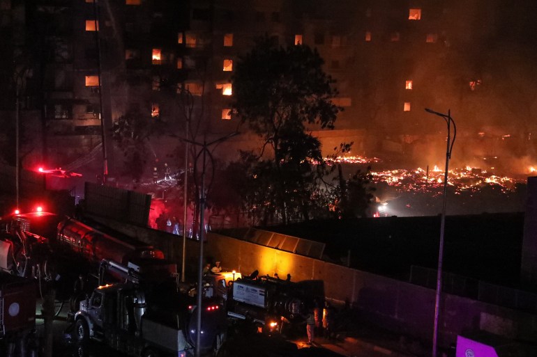 Firefighters battle the flames at the Al-Ahram Studio and surrounding buildings in Cairo's Giza district on March 16, 2024. - Flames overtook , one of the Arab world's most prestigious and oldest film production studios founded 80 years ago, burning everything inside and spreading to three surrounding buildings which were evacuated before the blaze reached them. (Photo by Momen SAMIR / AFP)