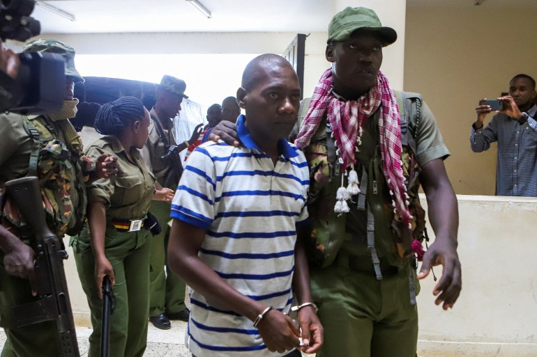 Paul Mackenzie, a Kenyan cult leader accused of ordering his followers, who were members of the Good News International Church, to starve themselves to death in Shakahola forest, is escorted to the Malindi Law Courts in Malindi, Kilifi, Kenya January 17, 2024. REUTERS/Stringer