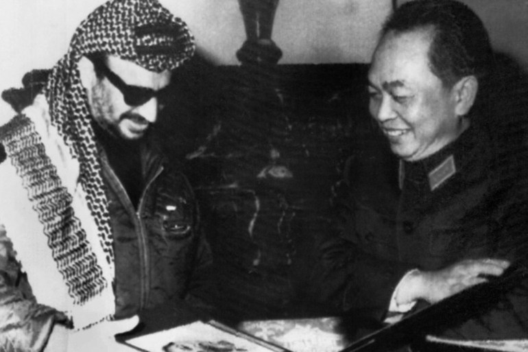 PLO leader Yasser Arafat, left, receives an album on the creation of the North Vietnamese army with a picture of Ho Chi Minh on the cover from North Vietnam's defence minister, General Vo Nguyen Giap, during Arafat's visit to North Vietnam in 1970 [File: AFP]