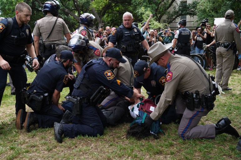 A person is detained by police as pro-Palestinian students protest the Israel-Hamas war on the campus of the University of Texas in Austin, Texas, on April 24, 2024. Universities have become the focus of intense cultural debate in the United States since the October 7 Hamas attack and Israel's overwhelming military response to it. (Photo by Suzanne CORDEIRO / AFP)