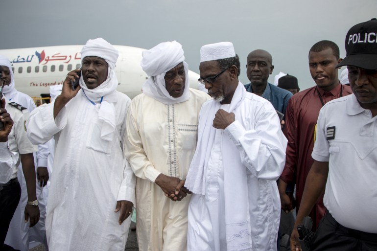 Timan Erdimi (C), leader of the rebel Union of Resistance Forces (UFR), greets his relatives who came to welcome him as he arrives at the N'Djamena International Airport in N'Djamena, Chad, on August 18, 2022, after 17 years in exile. Timan Erdimi, the head of the Union of Resistance Forces (UFR), has been living in exile in Qatar for at least a decade, after his rebel group attempted to overthrow former Chadian president Idriss Deby Itno, first in 2008 and again in 2019.
