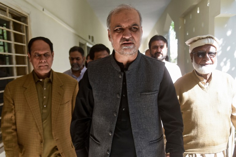 Hafiz Naeem Ur Rehman (C), Karachi Chief of Islamist party Jamaat-e-Islami (JI) arrives to submit nomination papers at the deputy commissioner office in Karachi on December 22, 2023, ahead of the upcoming 2024 general elections. (Photo by Rizwan TABASSUM / AFP)