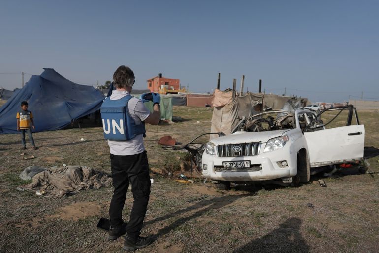 EDITORS NOTE: Graphic content / United Nations staff members inspect the carcass of a car used by US-based aid group World Central Kitchen, that was hit by an Israeli strike the previous day in Deir al-Balah in the central Gaza Strip on April 2, 2024, amid the ongoing battles between Israel and the Palestinian militant group Hamas. - The international food aid charity said on April 2 it was pausing its Gaza aid operations after seven of its staff were killed in a "targeted Israeli strike" as they unloaded desperately needed food aid delivered by sea from Cyprus. (Photo by AFP)