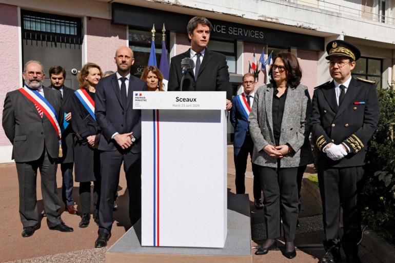 France's Prime Minister Gabriel Attal (C) delivers a speech next to France's Minister for Transformation and Public Services Stanislas Guerini (C,L), Sceaux's mayor Philippe Laurent (L) and Hauts-de-Seine prefect Laurent Hottiaux (R) after visiting a "France Services" facility in Sceaux, outside Paris, on April 23, 2024, following the 8th interministerial committee for Public transformation. - France Services facilities are local administrative hubs aimed at facilitating administrative procedures for citizens. (Photo by Ludovic MARIN / AFP)