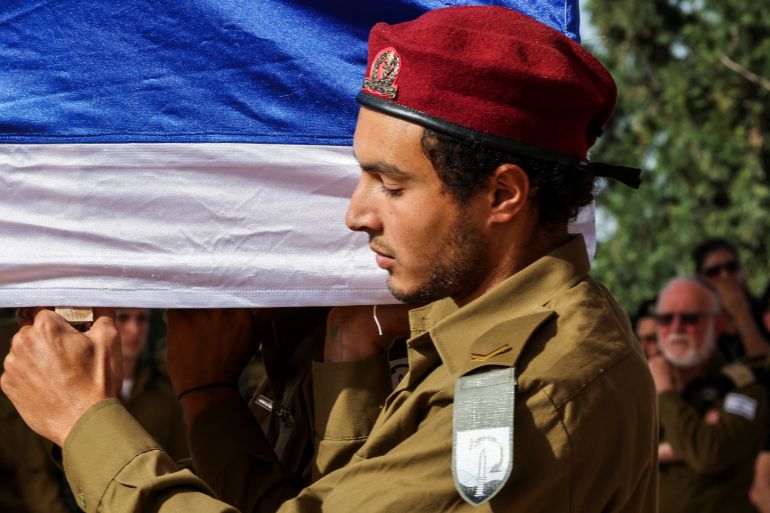 A soldier looks on as he carries the casket of Israeli soldier Sergeant Major Alon Kudriashov who was killed in Gaza during the ongoing conflict between Israel and the Palestinian Islamist group Hamas, at his funeral, in Modiin, Israel, March 31, 2024. REUTERS/Nir Elias