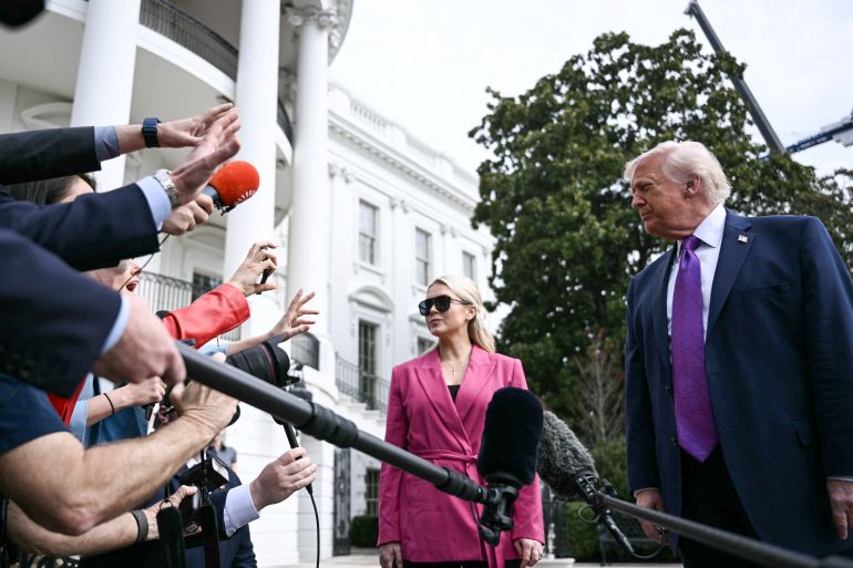 (FILES) US President Donald Trump speaks to reporters alongside White House Press Secretary Karoline Leavitt before departing from the South Lawn of the White House in Washington, DC, on March 11, 2026.