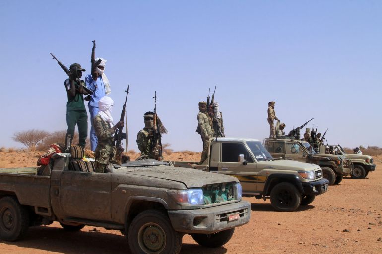 Armed defectors from Sudan’s paramilitary Rapid Support Forces (RSF) arrive in vehicles as they surrender to the Sudanese army in western Omdurman [Ebrahim Hamid / AFP]