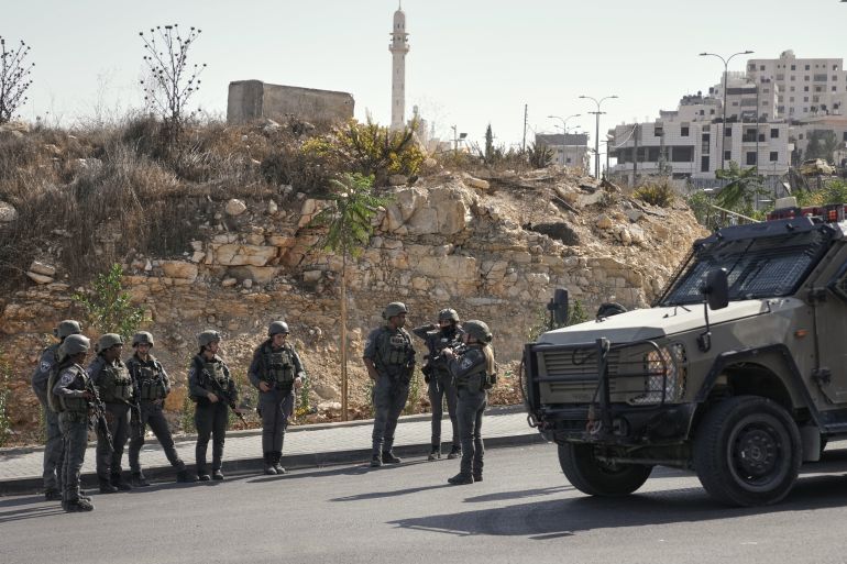 Israeli soldiers gather at the scene of a shooting attack carried out by Palestinian gunmen at a junction near Hebron in the occupied West Bank on Friday, Oct. 23, 2026. (AP Photo/Mahmoud Illean)
