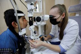 Ophthalmologist Sasha Khantil, whose father is a member of the Ukrainian army, examines the eyes of a Kurdish boy, at her clinic in the Kalak district on the outskirts of Erbil, Iraq, March 2, 2022. Picture taken March 2, 2022. REUTERS/Azad Lashkari