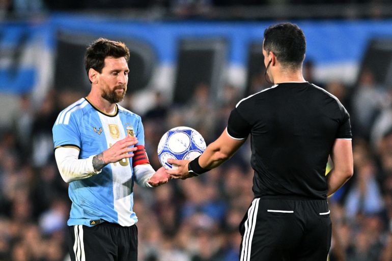 Soccer Football - International Friendly - Argentina v Benin - Estadio Monumental, Buenos Aires, Argentina - October 6, 2026 Referee Fernando Vejar hands the ball to Argentina's Lionel Messi after the end of his final international match REUTERS/Rodrigo Valle