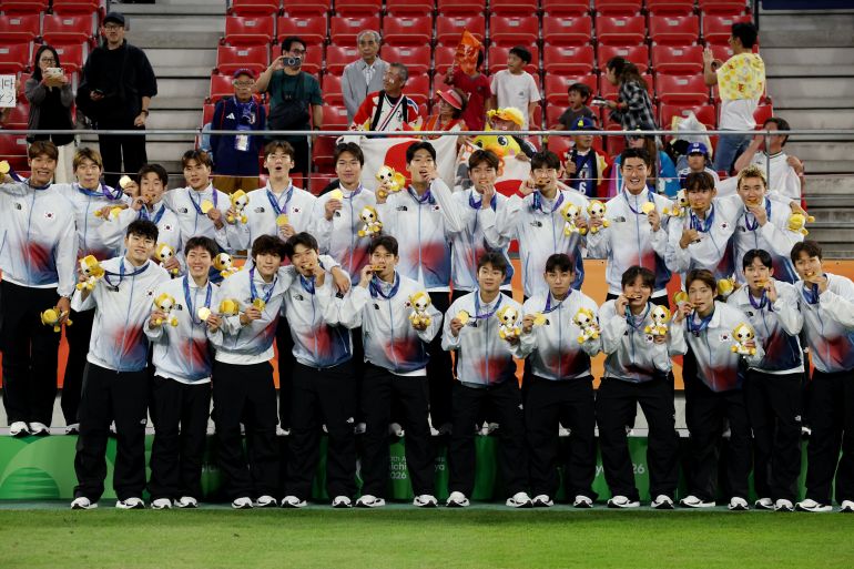 Asian Games - Aichi-Nagoya 2026 - Soccer Football - Men's Final - South Korea v Japan - Toyota Stadium, Toyota, Japan - October 3, 2026 Gold medallists South Korea celebrate on the podium during the victory ceremony REUTERS/Andrew Boyers