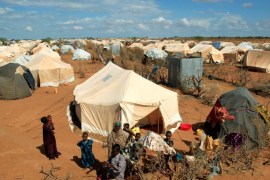 Refugees stand outside their tent at the Ifo Extension refugee camp in Dadaab, near the Kenya-Somalia border in Garissa County, Kenya October 19, 2011. REUTERS/Thomas Mukoya/File Photo