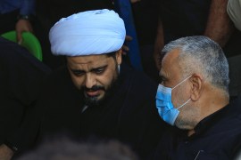 Qais al-Khazali, leader of Asaib Ahl al-Haq and Hadi al-Amiri, leader of the Badr Organisation, attend a symbolic funeral of supporters of Iraqi Shiite armed groups who were killed in a protest in Baghdad