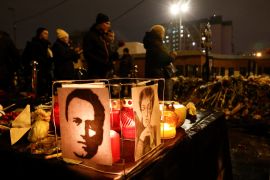 A view shows portraits of late Russian opposition politician Alexei Navalny and journalist Anna Politkovskaya, as people visit Navalny's grave following his funeral at the Borisovskoye cemetery in Moscow, Russia, March 1, 2024. REUTERS/Stringer